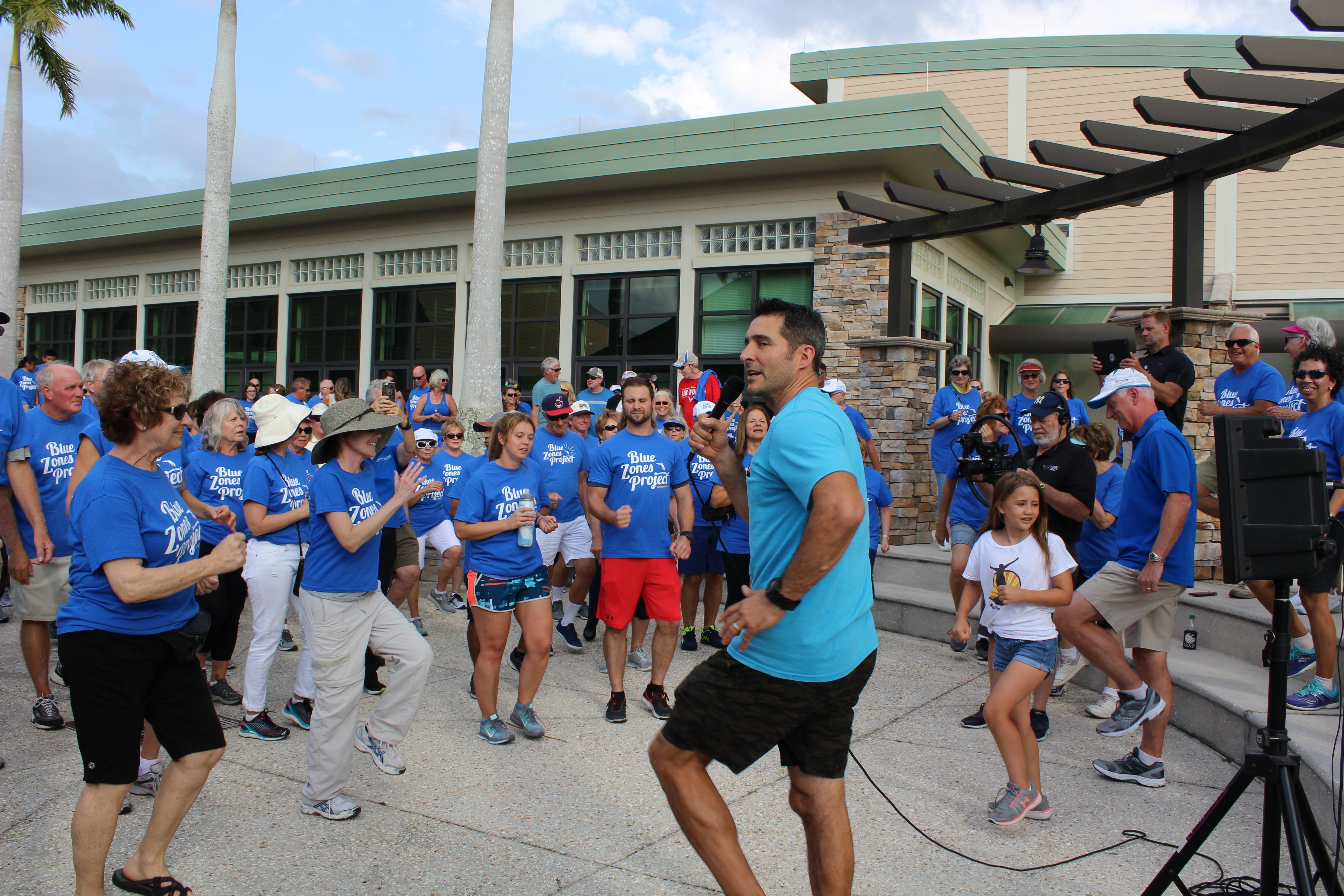 Nino Magaddino from MaxFlex Fitness getting Track Your Trek participants warmed up on National Walking Day-1